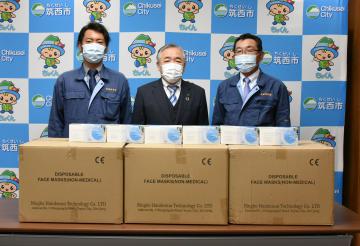 須藤茂市長に寄贈のマスクを届けた高橋俊輔専務(左)と藤枝祥一事務局長(右)=筑西市役所