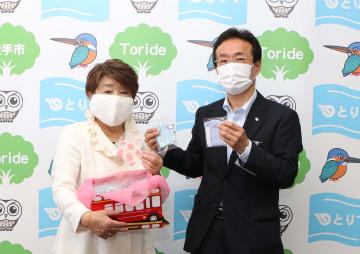 吉田雅弘取手市副市長(右)に手作りマスクを手渡す小林知江代表=同市役所
