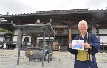 大聖寺の歴史を語りながら7月の御朱印を手に持ちほほ笑む小林隆成住職=土浦市永国