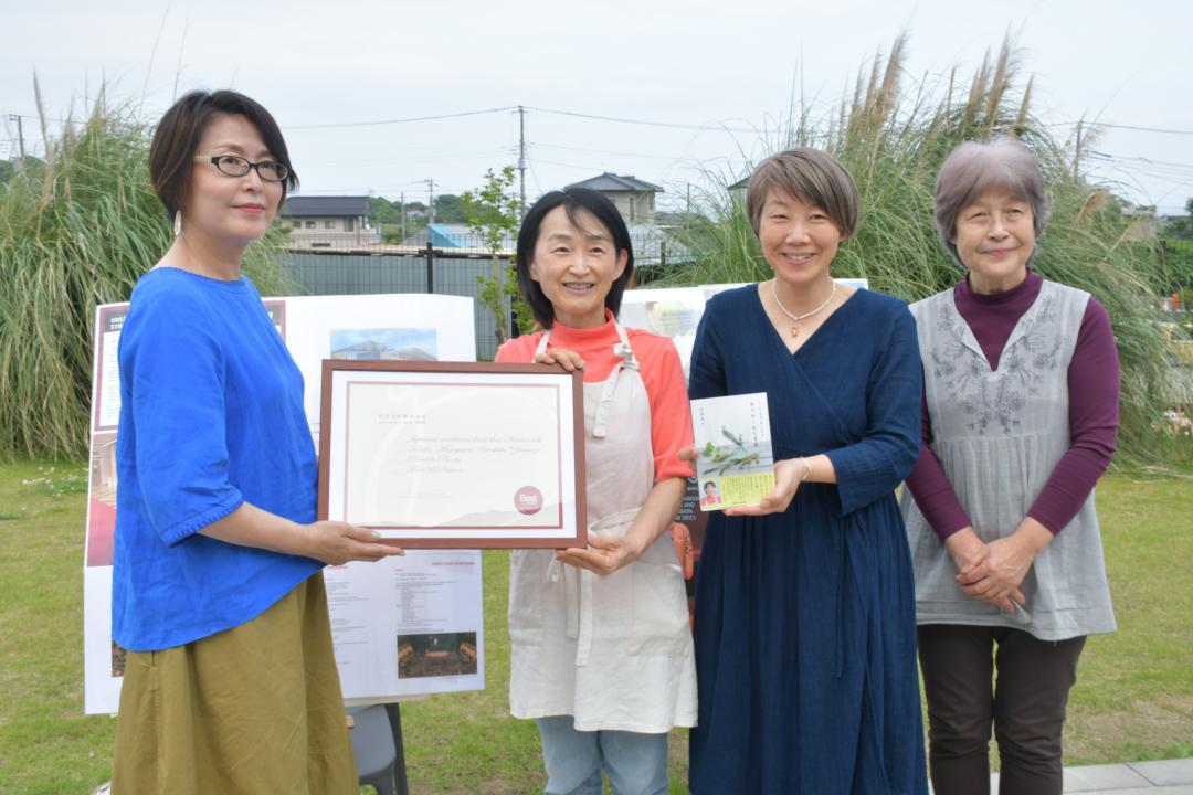編集協力者などと記念撮影する宮沢孝子さん(左から2人目)=日立市東滑川町