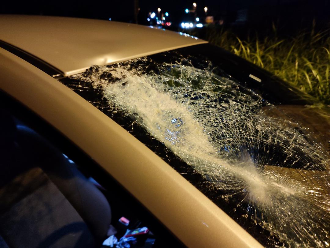 フロントガラスが大きく破損した車(男性提供)