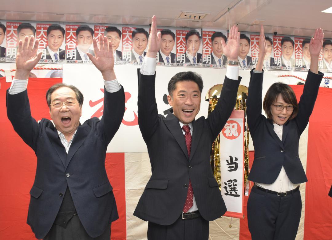 ひたちなか市長選で再選を決め、万歳する大谷明氏(中央)=同市馬渡