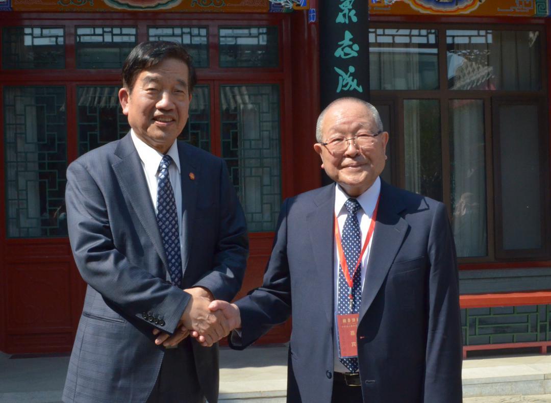 式典後に握手を交わす星弘道さん(右)と蘇士澍さん=北京市内
