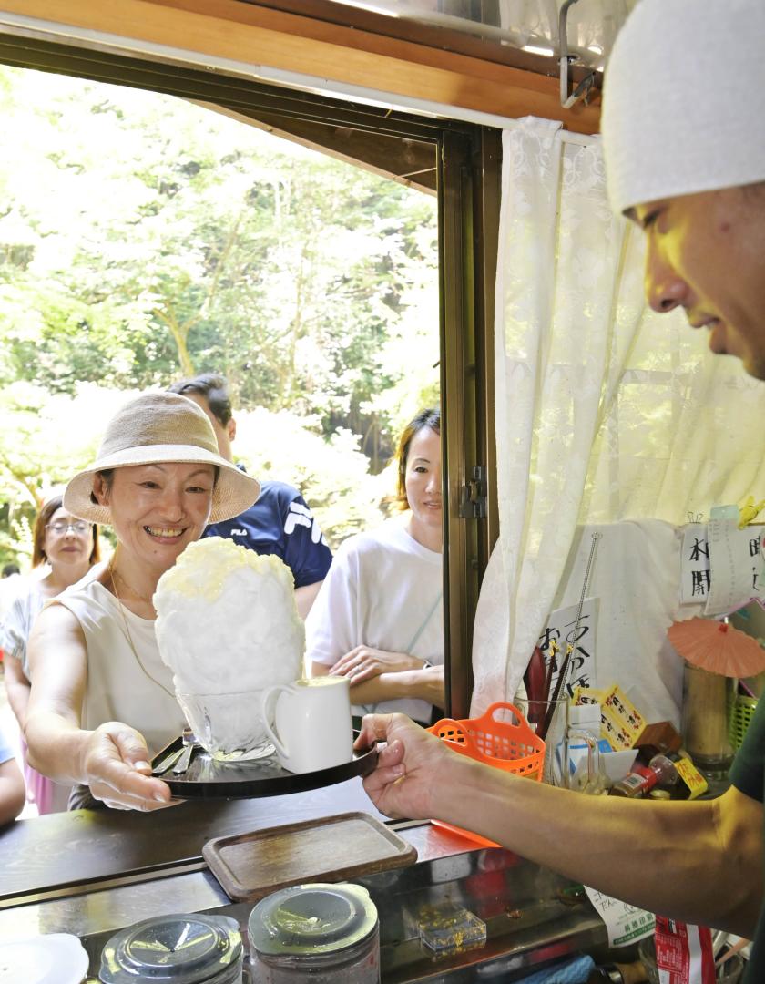 天然氷のかき氷でを受け取る観光客=大子町川山