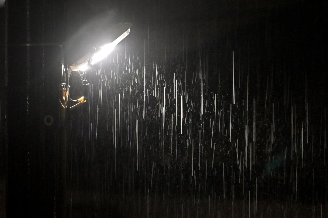 街頭に照らされる雨