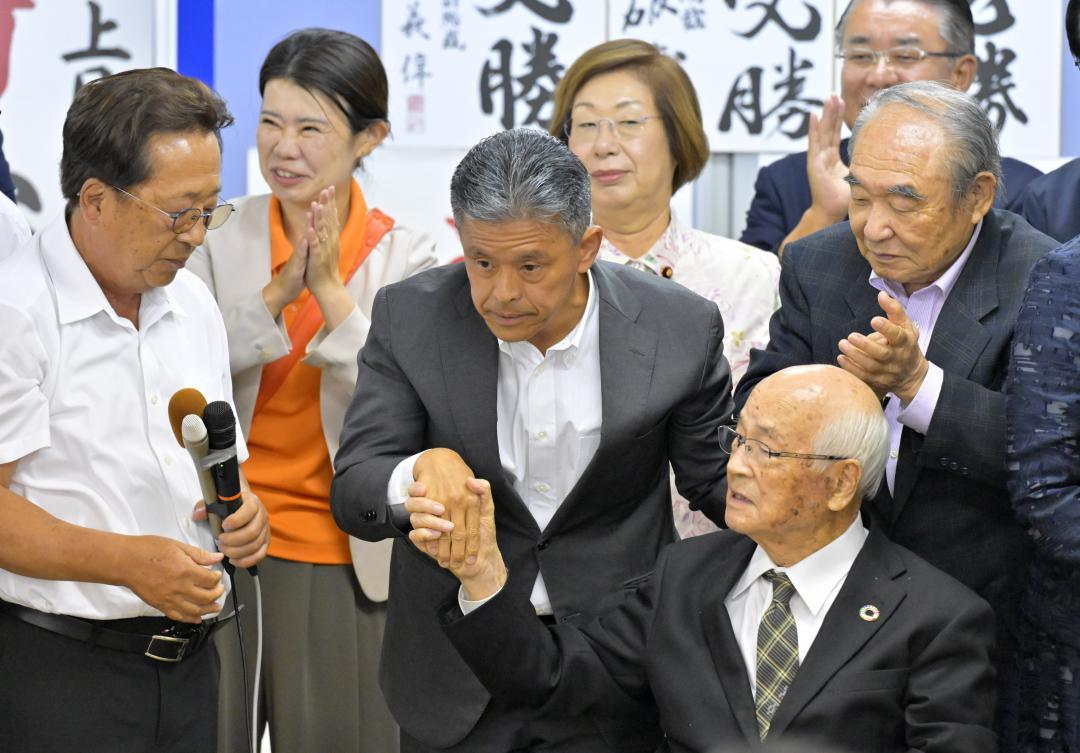 3度目の当選を確実にし、関係者から祝福を受ける上月良祐氏(中央)=20日午後10時18分、水戸市泉町