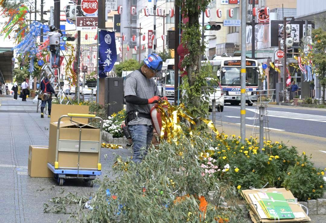 台風9号接近に伴い竹飾りやちょうちんなどを撤去する関係者=水戸市南町
