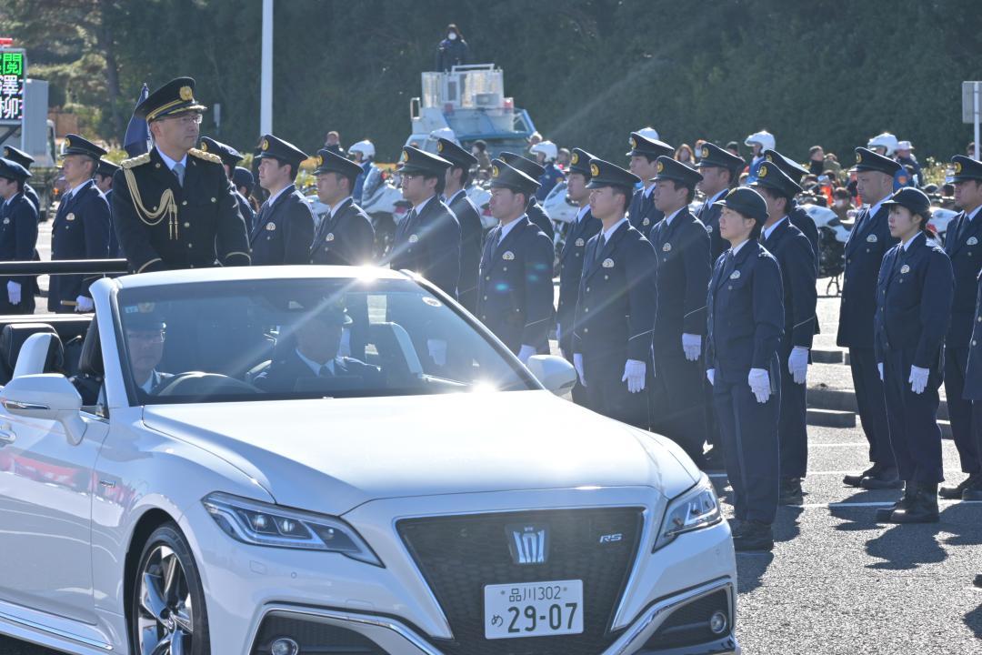 オープンカーで部隊を巡閲する滝沢幹滋本部長=ひたちなか市阿字ケ浦町